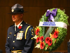 An Alberta Sheriff stands at watch near a wreath during the "We Have Not Forgotten" Bar Call ceremony in the Ceremonial Courtroom at the Calgary Courts Centre on Friday, November 9, 2018 in remembrance of 37 Alberta law students who did not return home from WW l. Jim Wells/Postmedia