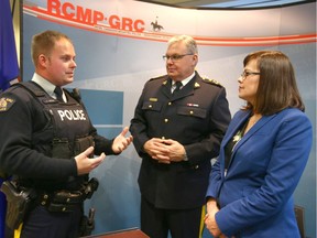 Justice Minister Kathleen Ganley speaks with RCMP members in Calgary on Tuesday, Nov. 13, 2018. Ganley criticized a joint UCP/Conservative party report suggesting changes to RCMP contract policing in the province.