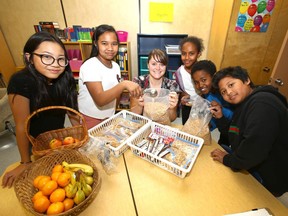Students (left to right) Sophia, Cashryle, Sara, Fikadu and Angelo join teacher Lindsay Dell at St. Mark Elementary School in northeast Calgary. Dell oversees a Samaritan Club food program for students. Samaritan Club is one of the recipients of the 2018 Calgary Herald Christmas Fund.