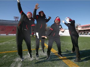 Offensive lineman (L-R) Justin Lawrence, Justin Renfrow, Ucambre Williams, and Randy Richards are more than enthusiastic to show off their matching onsies during a light practice at McMahon Stadium in Calgary on Saturday, November 17, 2018. The Stampeders host the Winnipeg Blue Bombers in the CFL Western Final on Sunday. Jim Wells/Postmedia