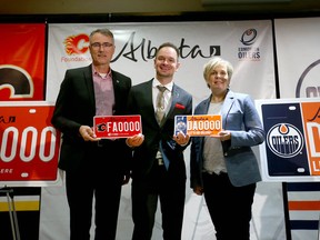 (L-R) John Bean, president Calgary Sports and Entertainment Corporation, Brian Malkinson, Minister of Service Alberta and Natalie Minckler, executive director, Edmonton Oilers Community Foundation pose with new personalized plated in Calgary on Saturday, November 17, 2018. Starting November 19, Albertans can show support for their favorite Alberta NHL team on their vehicles by buying a license plate for $ 75.00 plus service charges. Fifty five dollars will go to either the Calgary Flames Foundation or the Edmonton Oilers Community Foundation and $20 goes to the government. Jim Wells/Postmedia