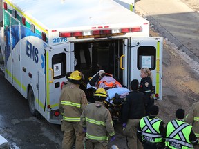 Emergency workers load a woman into an ambulance at the Victoria Park/Stampede CTrain platform on Thursday, Nov. 9, 2018. The woman was allegedly pushed onto the tracks as a train approached. The CTrain was able to stop before reaching the victim. The elderly woman was taken to hospital in life-threatening condition.