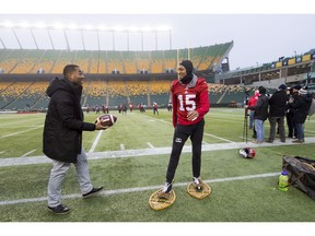 A reporter passes Calgary Stampeders wide receiver Eric Rogers (15) a football as he jokes around on a pair of snowshoes in Edmonton on Friday. The Ottawa Redblacks will play the Calgary Stampeders in the 106th Grey Cup on Sunday.