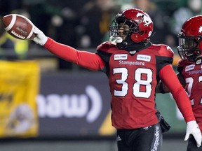 Calgary Stampeders running back Terry Williams (38) celebrates a punt return touchdown against the Ottawa Redblacks with teammate defensive back Tunde Adeleke (27) during the first half of the 106th Grey Cup in Edmonton, Alta. Sunday, Nov. 25, 2018.