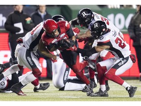 Calgary Stampeders wide receiver Eric Rogers (15) is tackled by the Ottawa Redblacks during the first half of the 106th Grey Cup in Edmonton, Alta. Sunday, Nov. 25, 2018.