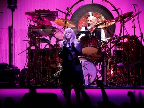 Stevie Nicks in front of drummer Mick Fleetwood of Fleetwood Mac performing at the Scotiabank Saddledome in Calgary, Alta., on Friday November 14, 2014. Mike Drew/Calgary Sun/QMI Agency