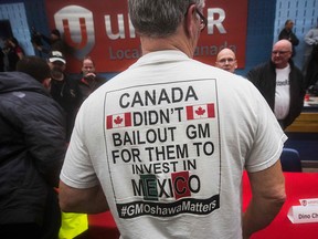 A worker wears a t-shirt during an information session at Local 222 in Oshawa, Ont., on Nov. 26, 2018, where workers learned details of GM's cuts.