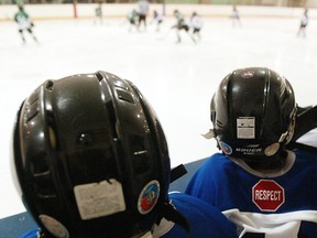 Minor hockey players on the bench during Esso Minor Hockey Week in Calgary.