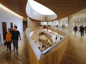Visitors explore the New Central Library following its opening on Nov. 1, 2018. The four-storey building cost $245 million to construct and the 240,000-square-foot interior centres around a four-storey central atrium topped by a skylight.