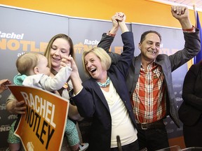 Calgary-East candidate Robyn Luff, left, holding her daughter Vesper, campaigns with Alberta NDP Leader Rachel Rachel Notley and Calgary-Fort NDP candidate Joe Ceci on April 8, 2015. Luff, an NDP  backbencher, says she won't take her seat in the legislature to draw attention to what she calls a "toxic culture" in the governing caucus.