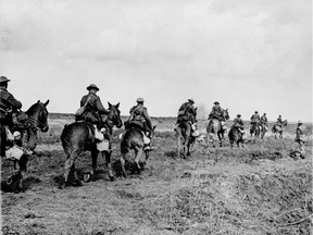 FILE-The horrors of the First World War have dwindled in the mists of time, reduced to little more than a few faded sepia photographs.This is a  April 1917 photo showing The Canadian Light Horse going into action at Vimy Ridge. April, 1917. National Archives of Canada)
