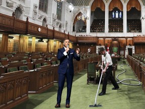 Maintenance worker Andre Dube uses a vacuum to clean and prepare the House of Commons at Parliament Hill Ottawa Wed Sept 14, 2012.(ANDRE FORGET/QMI AGENCY; National Post Photo Illustration)