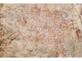 This composite image from the book "Borneo, Memory of the Caves" shows the world's oldest figurative artwork dated to a minimum of 40,000 years, in a limestone cave in the Indonesian part of the island of Borneo. Scientists say the red silhouette of a bull-like beast, upper left, is the oldest known example of animal art.