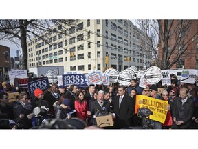 New York City Councillor Jimmy Van Bramer, center, speaks during a coalition rally and press conference of elected officials, community organizations and unions opposing Amazon headquarters getting subsidies to locate in the New York neighborhood of Long Island City, Queens, Wednesday Nov. 14, 2018, in New York.
