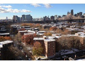 The Queensbridge Houses sit beneath the Ed Koch Queensboro Bridge, upper right, Friday, Nov. 16, 2018, in New York. Like most New York City housing projects, Queensbridge residents complain of poor conditions, lacking heat or hot water, or rats and roaches. The city has come under sharp criticism for the conditions of its public housing. Amazon is proposing to build a new headquarters nearby.