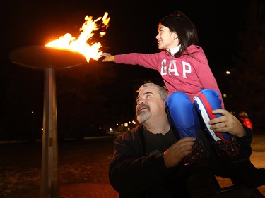Dad, Robert Marr and his daughter, Abigail, 9, check out the Olympic cauldron lit up at the Olympic Oval in Calgary on Tuesday Nov. 13, 2018.