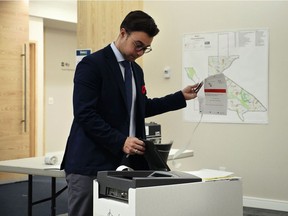 Bill Myers, with the Election and Census Division at the City of Calgary, demonstrates an electronic tabulator machine which will be utilized in the Olympic plebiscite.