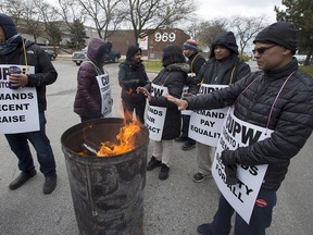 Striking Canada Post workers picket at the South Central sorting facility in Toronto on Tuesday, Nov. 13, 2018.