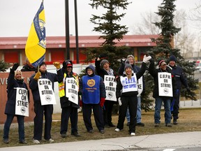 Calgary Postal workers hit the picket lines again at their headquarters in Calgary on Monday, Nov. 5, 2018.