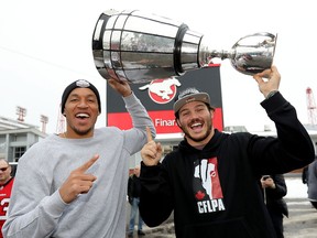Calgary Stampeders Eric Rogers (left) and Alex Singleton hoist the Grey Cup as the team returned to McMahon Stadium on Monday, Nov. 26, 2018.