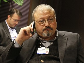 In this Jan. 29, 2011, file photo, Saudi Arabian journalist Jamal Khashoggi speaks on his cellphone at the World Economic Forum in Davos, Switzerland.
