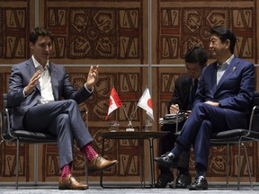 Prime Minister Justin Trudeau speaks with Japanese Prime Minister Shinzo Abe during a bilateral meeting at the APEC Summit in Port Moresby, Papua New Guinea.