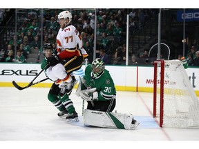 Ben Bishop #30 of the Dallas Stars makes a save in front of Mark Jankowski #77 of the Calgary Flames in the second period at American Airlines Center on Tuesday night in Dallas.