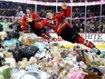 Calgary Hitmen Layne Bensmiller, left, and Radel Fazleev dive into a pile of bears during the annual Teddy Bear Toss at the Saddledome in 2015. The Hitmen set a world record of 28,815 stuffed animals collected, which stood for three years until the record was broken by the AHL's Hershey Bears on Sunday, Dec. 2, 2018.
