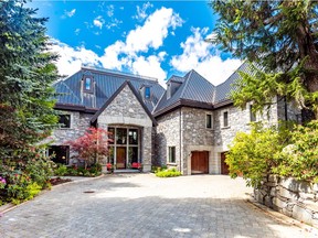 A luxurious 9,940-square-foot property tucked away on Whistler's Nita Lake is going up for international auction later this month for about half as much as it was previously listed for.