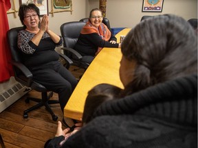 Josie Nepinak, executive director, left, and Jackie Bromley, cultural lead elder, trie to get a smile out of a young client and her mom at Awo Taan, an Indigenous-focused shelter for people experiencing family violence in Calgary, Ab., on Wednesday November 21, 2018. Mike Drew/Postmedia