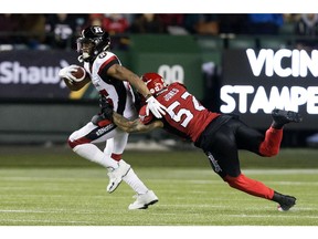 The Calgary Stampeders' Riley Jones (52) tackles the Ottawa Redblacks' Diontae Spencer (85) during second half Grey Cup action at Commonwealth Stadium, in Edmonton Sunday November 25, 2018. Calgary won 27 to 16.  Photo by David Bloom