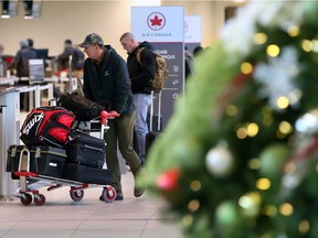 Passengers check in on the departures level at the Calgary International Airport on Monday morning December 17, 2018. The airport is preparing for some of the busiest travel days of the year as Christmas approaches. Gavin Young/Postmedia