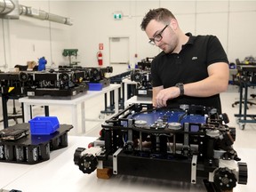 File photo: Nick Cowley of ATTAbotics Inc. builds robot canisters in Calgary on Wednesday, Dec. 12, 2018.