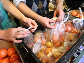 Community Kitchen volunteers bag some of the fruit and vegetables for the program's Good Food Boxes. Another program called Spinz-Around passes leftover food items from vendors to front line agencies.