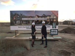 Julia Kotelnikova, sales associate for the Carrington Urban Terraces, and Charron Ungar, CEO of Homes by Avi Group of Companies, break ground on the Avi Urban project in Carrington.