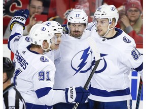 Tampa Bay Lightning's Alex Killorn (17) celebrate his goal with teammates Steven Stamkos (91) and Erik Cernak, (81) of Slovakia, during second period NHL hockey action against the Calgary Flames in Calgary, Thursday, Dec. 20, 2018.THE CANADIAN PRESS/Jeff McIntosh ORG XMIT: JMC111