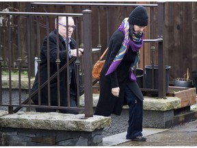 Huawei chief financial officer Meng Wanzhou, leaves her home with a security guard in Vancouver on Wednesday, December 12, 2018.
