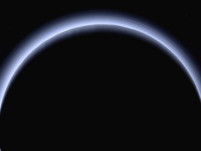 FILE - This image made available by NASA in March 2017 shows Pluto illuminated from behind by the sun as the New Horizons spacecraft travels away from it at a distance of about 120,000 miles (200,000 kilometers). The probe will ring in 2019 by exploring an even more distant and mysterious world. (NASA/Johns Hopkins University Applied Physics Laboratory/Southwest Research Institute via AP)