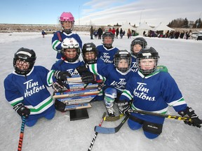 Members of the Chestermere Tyke Blue team celebrate after winning their division at the Western Canadian Pond Hockey Championships in Chestermere, east of Calgary on Saturday, December 29, 2018. Over 60 teams, from age 5 to adults, participted in the 3 day event. Jim Wells/Postmedia