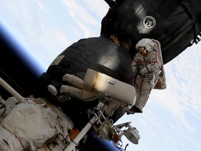 In this Dec. 11, 2018 file image from video made available by NASA, Russian cosmonaut Oleg Kononenko, right, and Sergei Prokopyev perform a spacewalk outside the Soyuz spacecraft attached to the International Space Station.