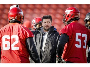 Runningbacks coach Brent Monson calls a play between Edwin Harrison (L) and Brad Erdos during a Calgary Stampeders practice at McMahon Stadium in Calgary, Alta. on Wednesday, Nov. 19, 2014. The Stamps will host the Edmonton Eskimos in the CFL's West Division final on Sunday. Lyle Aspinall/Calgary Sun/QMI Agency