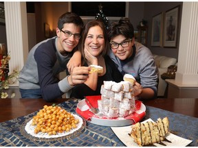 Anna Marinzi, chef and owner of Pizza on the Fly, a Roman-style pizza place with son's L-R, Marco and Tommaso and some of her Italian Christmas  foods at her home in Calgary for a story in Saturday life on Sunday December 9, 2018. Darren Makowichuk/Postmedia
