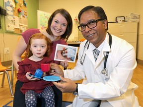 Dr. Abhay Lodha with Avril Strachan and her daughter Anna at the Alberta Children's Hospital on Dec. 11, 2018.