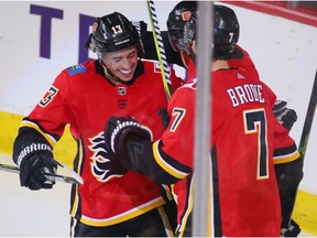 Johnny Gaudreau, Elias Lindholm and T.J. Brodie celebrate after Lindholm scored and Gaudreau assisted during NHL action against the Minnesota Wild at the Scotiabank Saddledome in Calgary on Thursday December 6, 2018. Gavin Young/Postmedia