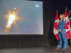 Canadian astronaut Jenni Sidey-Gibbons watches the launch of astronaut David Saint-Jacques for the international space station from Kazakhstan at the Canadian Space Agency headquarters Monday, Dec. 3, 2018 in St. Hubert, Que.