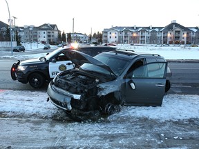 A heavily damaged car rests near the corner of 26th Avenue and 66th Street N.E. in Pineridge after a police chase on Dec. 17, 2018.