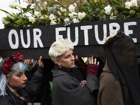 Climate change activists march a symbolic coffin towards Buckingham Palace during a protest on Nov. 24, 2018 in London.