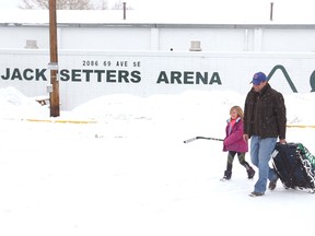 Kyle Mortson and his daughter leave Jack Setters Arena in southeast Calgary on Sunday, Dec. 2, 2018. The family arrived to play but the City of Calgary has closed the arena because of concerns over significant snow load on the roof.