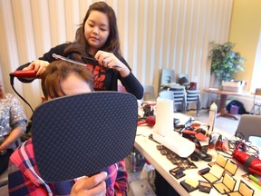 A client has her hair curled before a photo session at the Drop-In Centre in Calgary on  Saturday, December 1, 2018. Help Portrait Photography brings hairstylists, makeup artists and support volunteers to the DI to give clients the opportunity to have his or her hair and makeup done and a photo taken by a professional photographer. Participants received a photograph as a personal keepsake. (NOTE: At the request of the Drop-In Centre, the identity of the client is not shown). Jim Wells/Postmedia