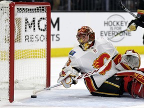 Flames goalie David Rittich sweeps away the puck after a Vegas Golden Knights goal Wednesday, Feb. 21, 2018, in Las Vegas.